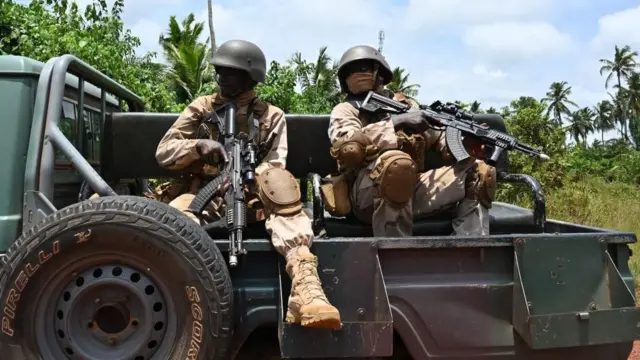 A Nigerian army general was slain in a nocturnal assault on the base; the military claims the attack was repulsed.